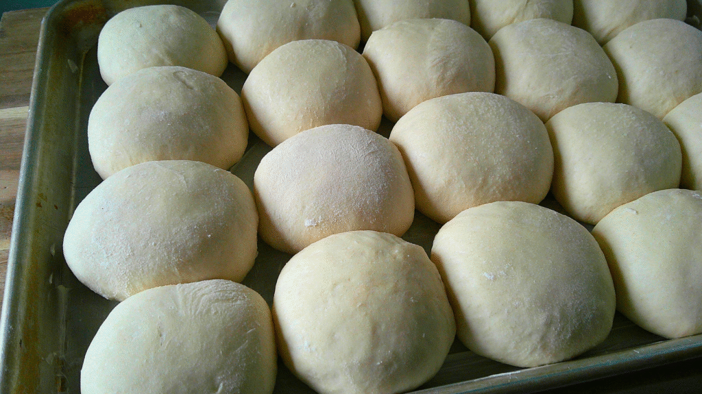 rolls rising on a pan